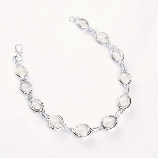 Elegant 13ctw cabochon moonstone tennis bracelet with silver links. A luminous white moonstone link bracelet perfect for any occasion.