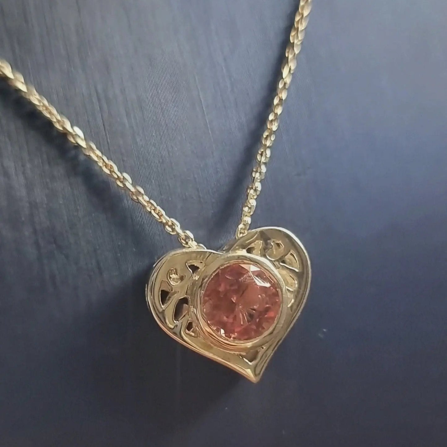 Detailed view of 18K Gold Heart Pendant with 4ct pink tourmaline, showcasing elegant curves and romantic design in fine jewelry collection.