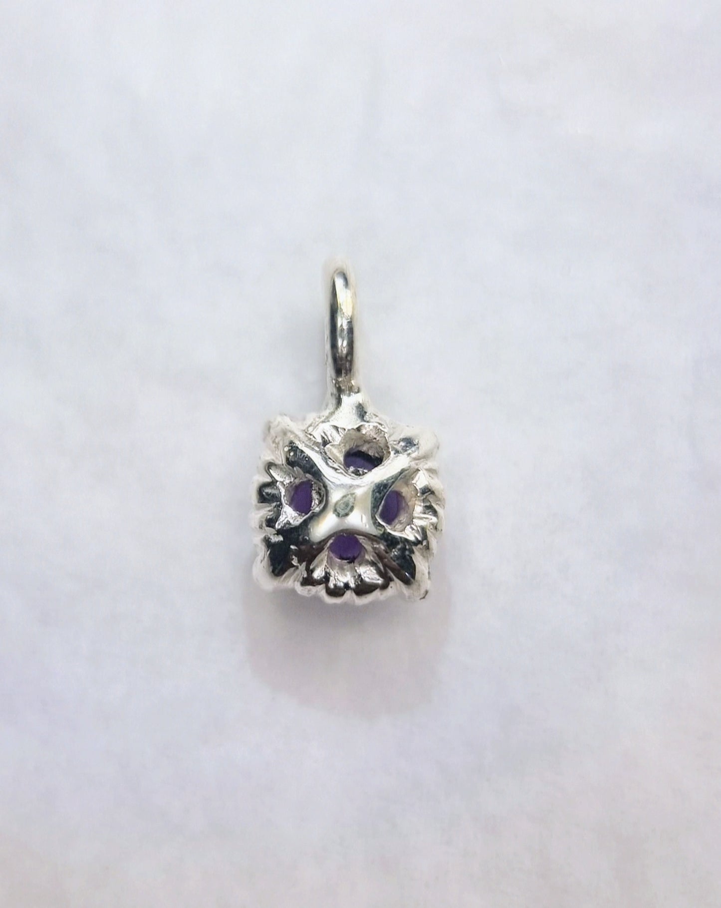 Rear view of Garnet Pendant Sterling Silver - Twist Design displaying floral-inspired silver pattern and gemstone support structure.