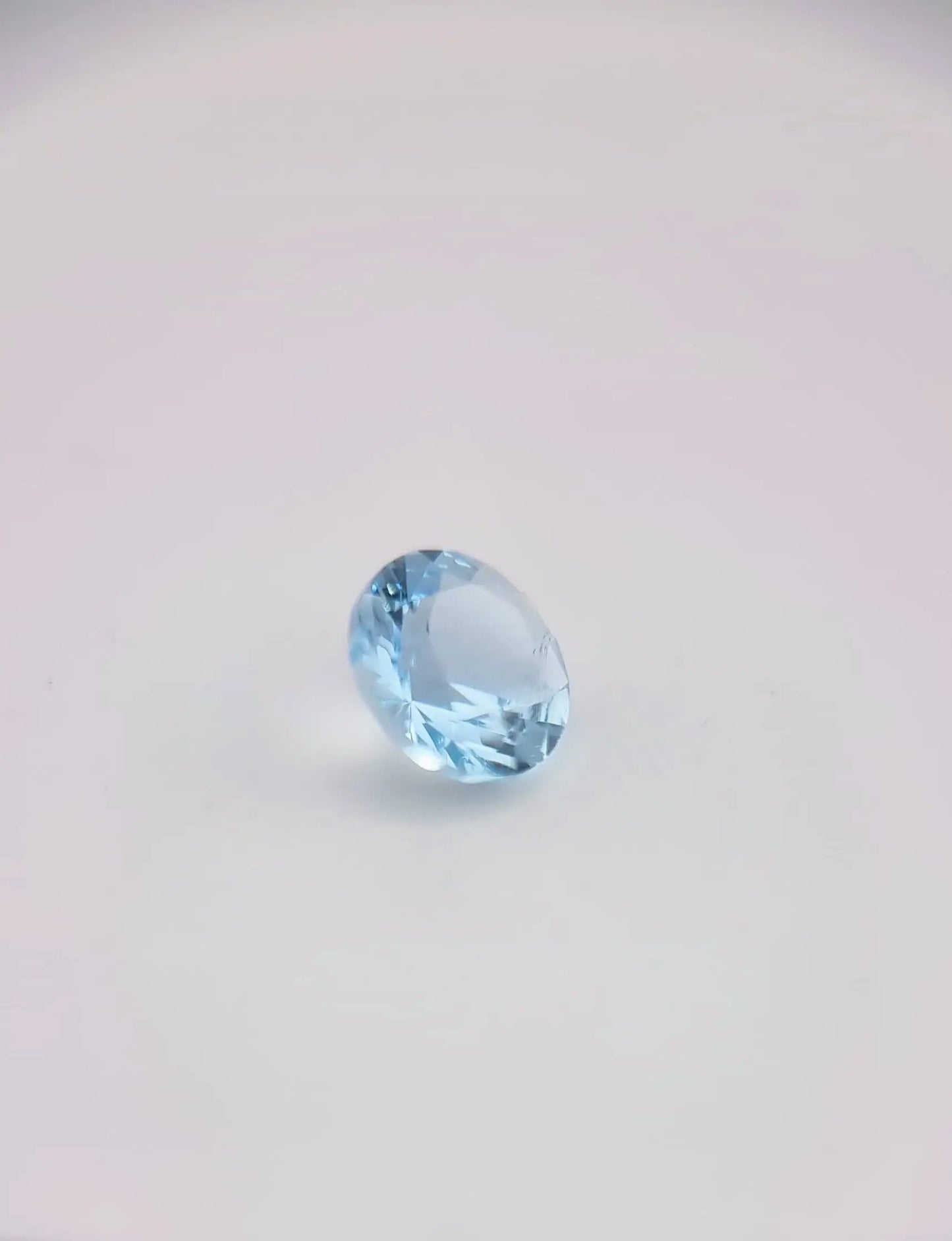 Oval-shaped aquamarine loose gemstone with high transparency and light blue tone, ideal for jewelry making or collections.