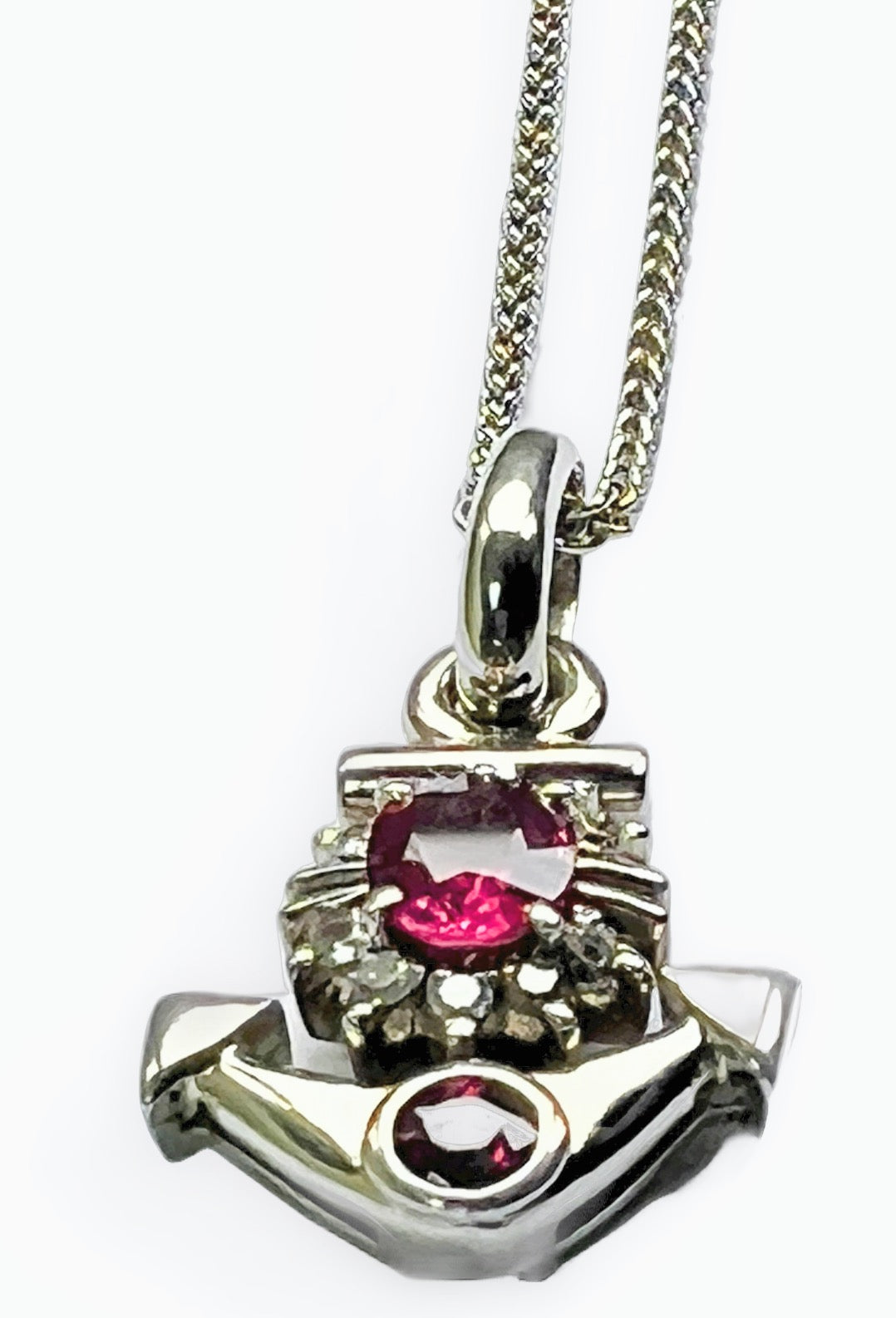 Close-up of Natural Ruby & Diamond Anchor Pendant Necklace in Platinum Coated Silver highlighting the oval ruby and sparkling diamond cluster.