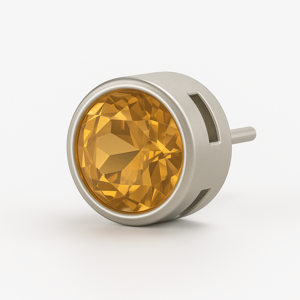 Close-up of round-cut citrine stud earring in a modern sterling silver geometric cage bezel setting, part of a mismatched earring pair.