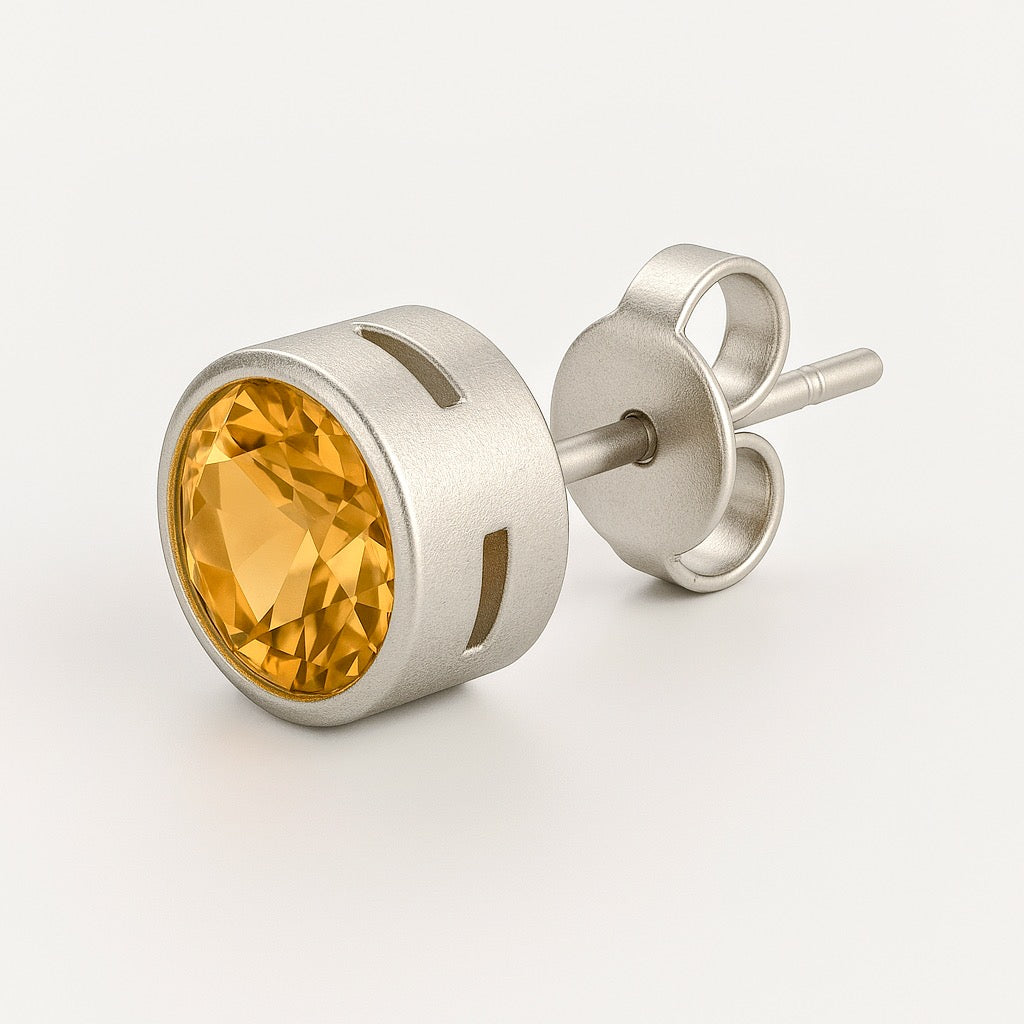 Side view of round-cut citrine stud earring in sterling silver geometric cage setting with secure post and butterfly back closure.