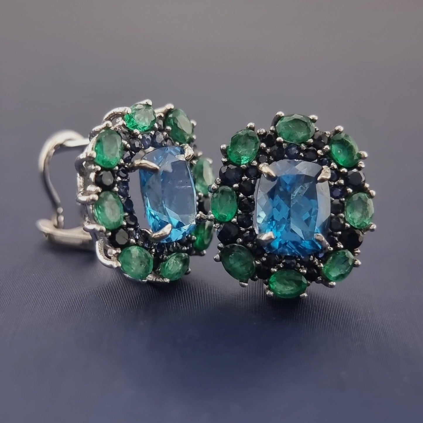 Close-up of Natural Topaz Emerald & Sapphire Platinum Earrings showing intricate gemstone arrangement and secure platinum clip-on backing.