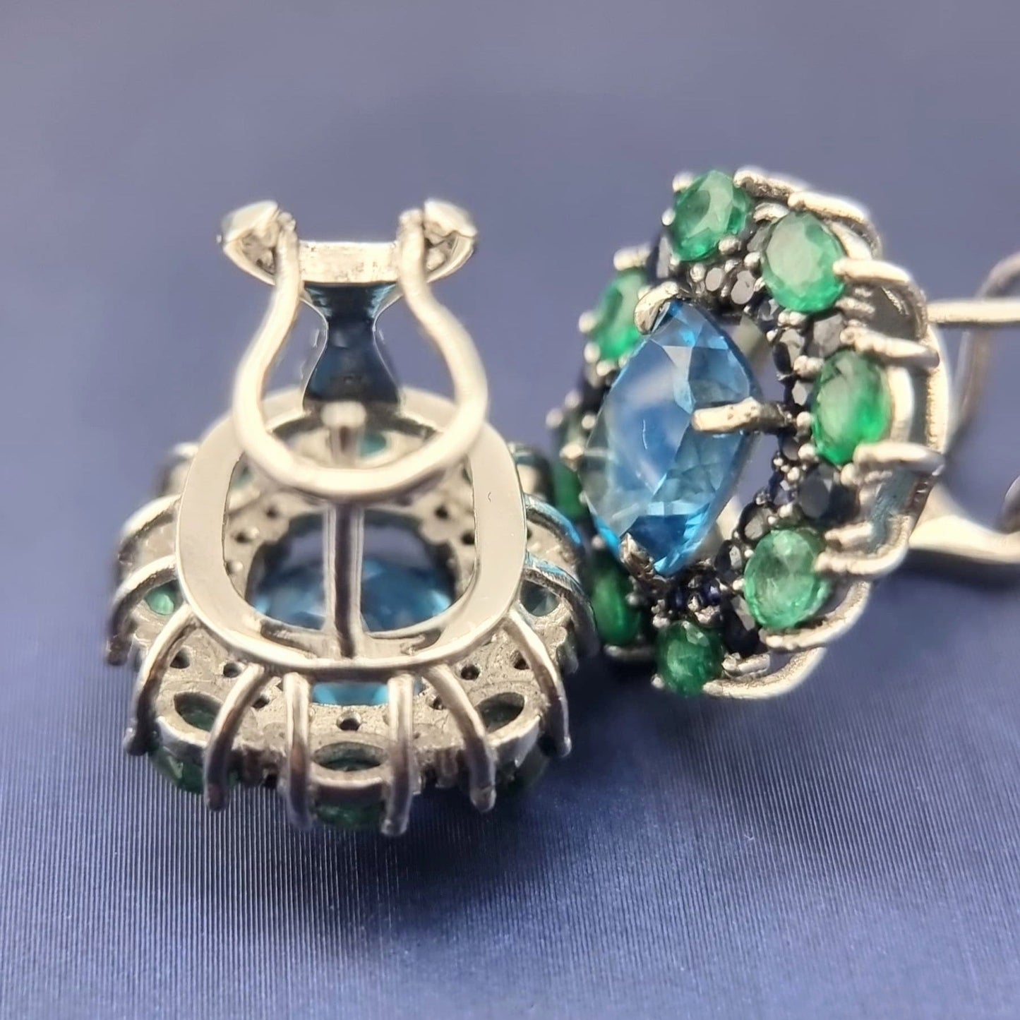 Underside of Natural Topaz Emerald & Sapphire Platinum Earrings revealing gemstone cut and platinum framework craftsmanship.
