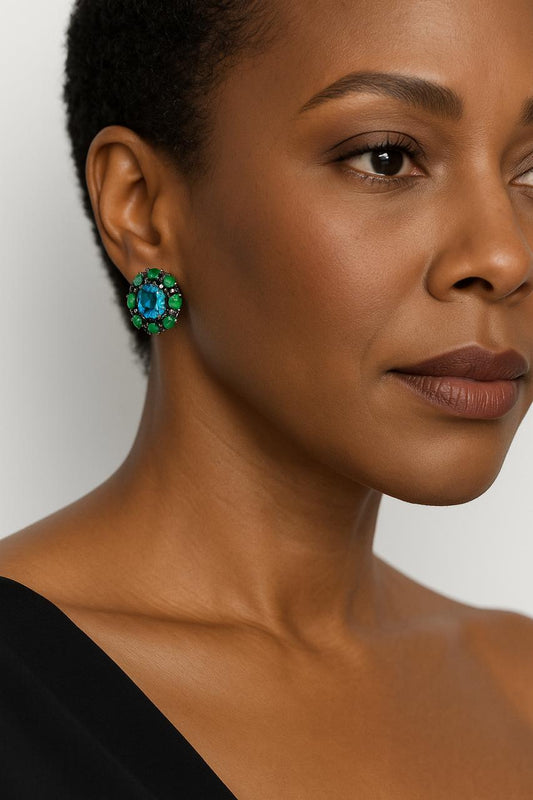 Model wearing Natural Topaz Emerald & Sapphire Platinum Earrings, showcasing the bold gemstone contrast and elegant platinum setting on the ear.