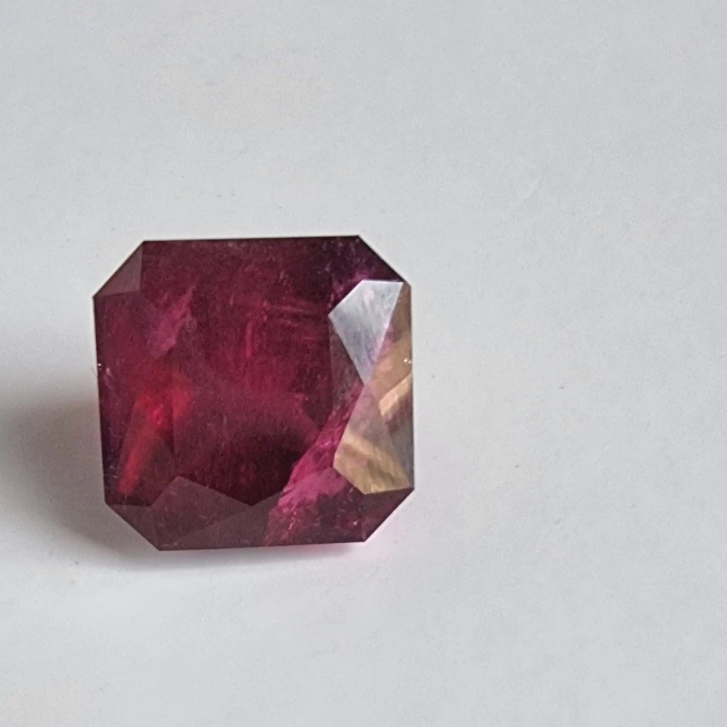 Loose 13.16ct Rubellite Tourmaline gemstone in square cut, featuring a vivid red hue suitable for luxury jewelry pieces.