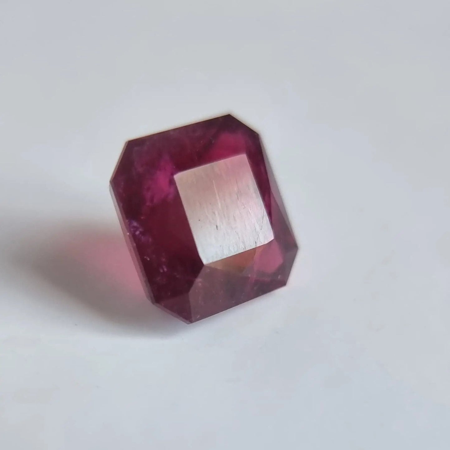 Square cut Rubellite Tourmaline gemstone weighing 13.16ct, with reflective facets and deep red tones for elegant jewelry.