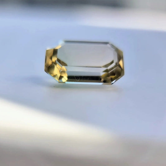 Rare 6.1ct bi-color tourmaline loose gemstone in emerald cut, showcasing natural clarity and dual-tone brilliance.