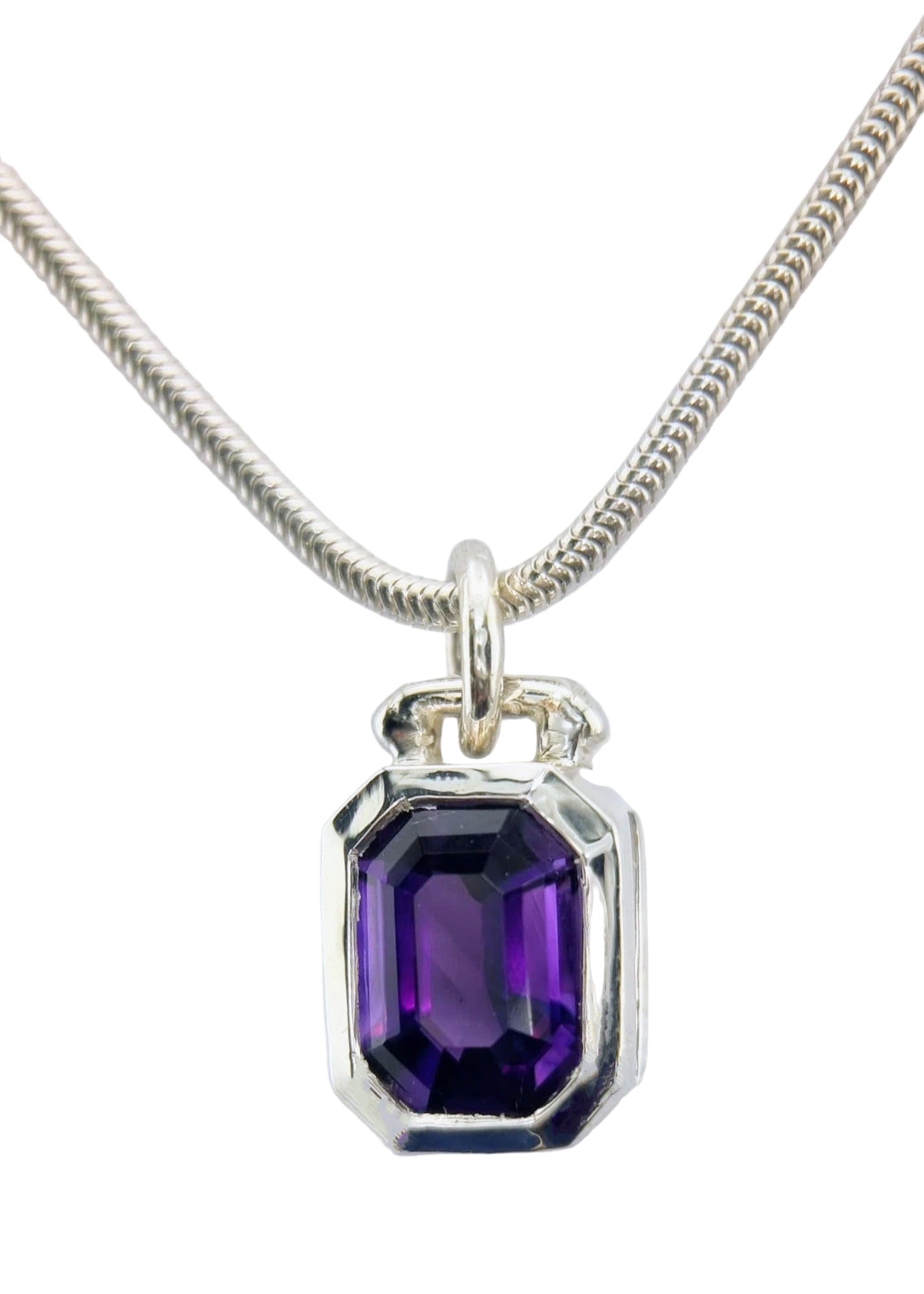 Full view of emerald cut amethyst sailor pendant in silver on chain, combining classic gemstone elegance with modern nautical flair.