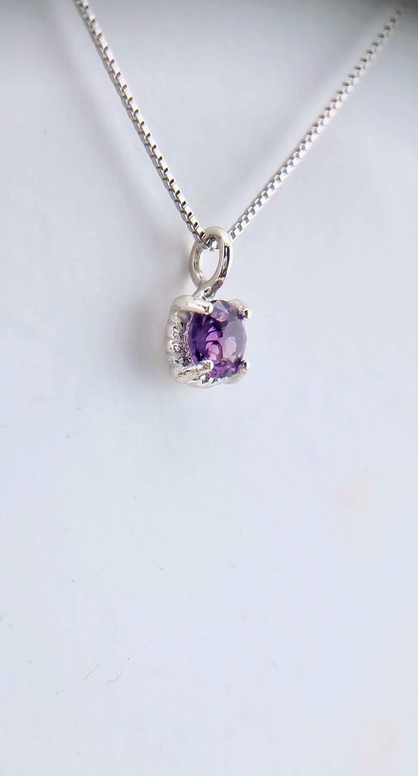Side view of the Amethyst Twist Pendant in Sterling Silver, highlighting the gemstone's depth and the elegant Italian chain.