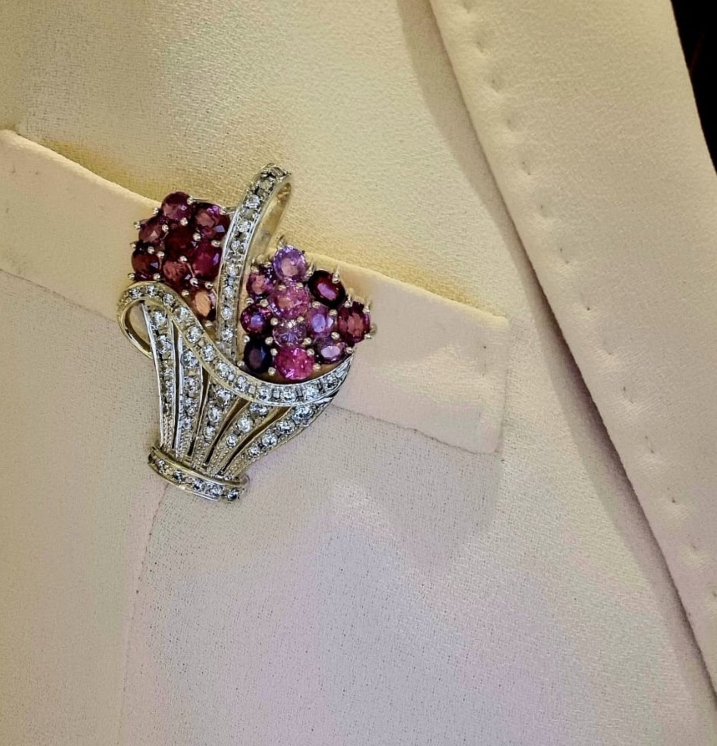 Natural Pink Sapphire Brooch Pendant styled on a cream blazer lapel, emphasizing its dual function as a brooch and statement accessory.