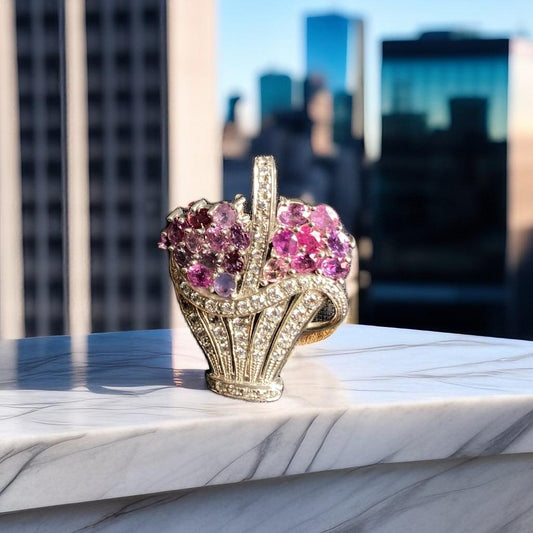 Natural Pink Sapphire Brooch Pendant displayed on marble with cityscape backdrop, showcasing exquisite gemstone sparkle and luxury craftsmanship.
