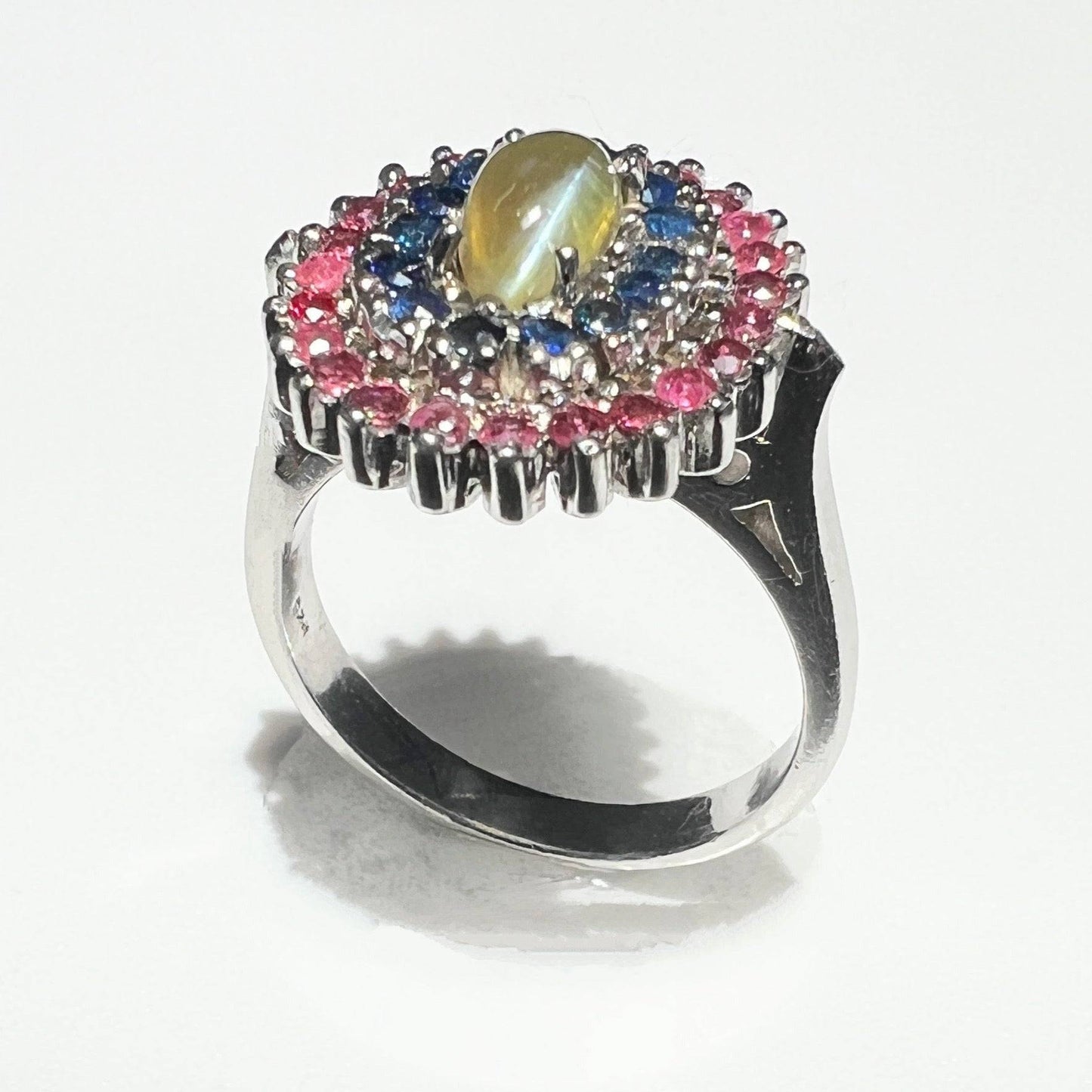 Close-up of the Cat's Eye Chrysoberyl and Sapphire Cocktail Ring, displaying the luminous cat's eye effect and vibrant sapphire accents.