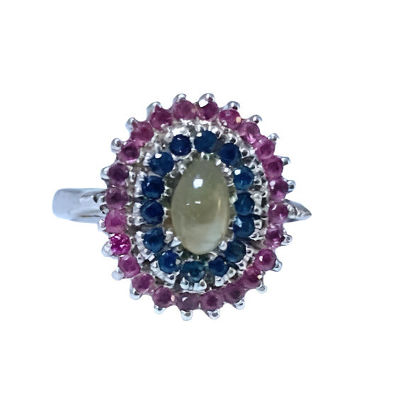 Natural Cat's Eye Chrysoberyl and Sapphire Cocktail Ring featuring an oval cat's eye chrysoberyl center stone, encircled by blue and pink sapphires.
