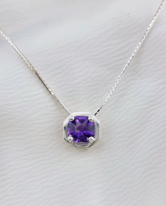 Sterling silver necklace with octagonal amethyst pendant displayed on a soft white background. Ideal accessory for stylish sophistication.