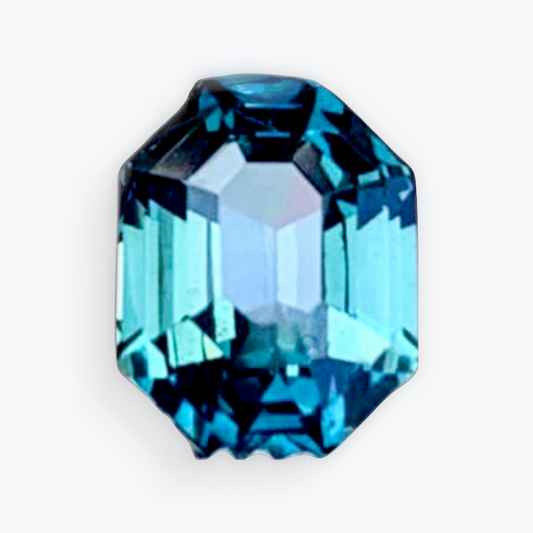 Close-up of a 2.5ct radiant cut blue teal sapphire gemstone with exceptional clarity and deep hues, perfect for fine jewelry settings.