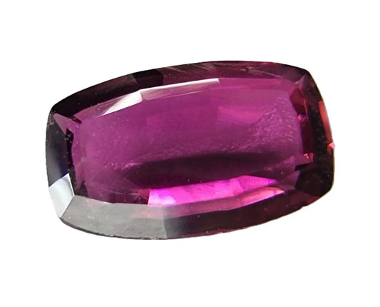 Elegant 2.6ct pinkish red rubellite tourmaline gemstone with an oval shape and faceted cut, perfect for collectors and bespoke jewelry creations.