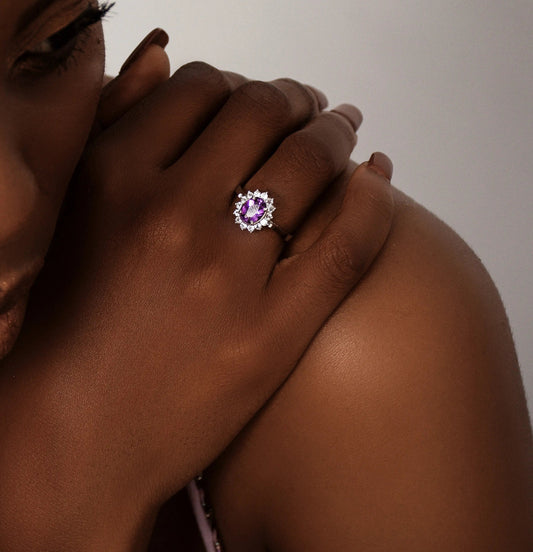 Model wearing a 2.0ct oval purple amethyst and white zircon ring, showcasing its radiant sparkle and elegant design on her hand.