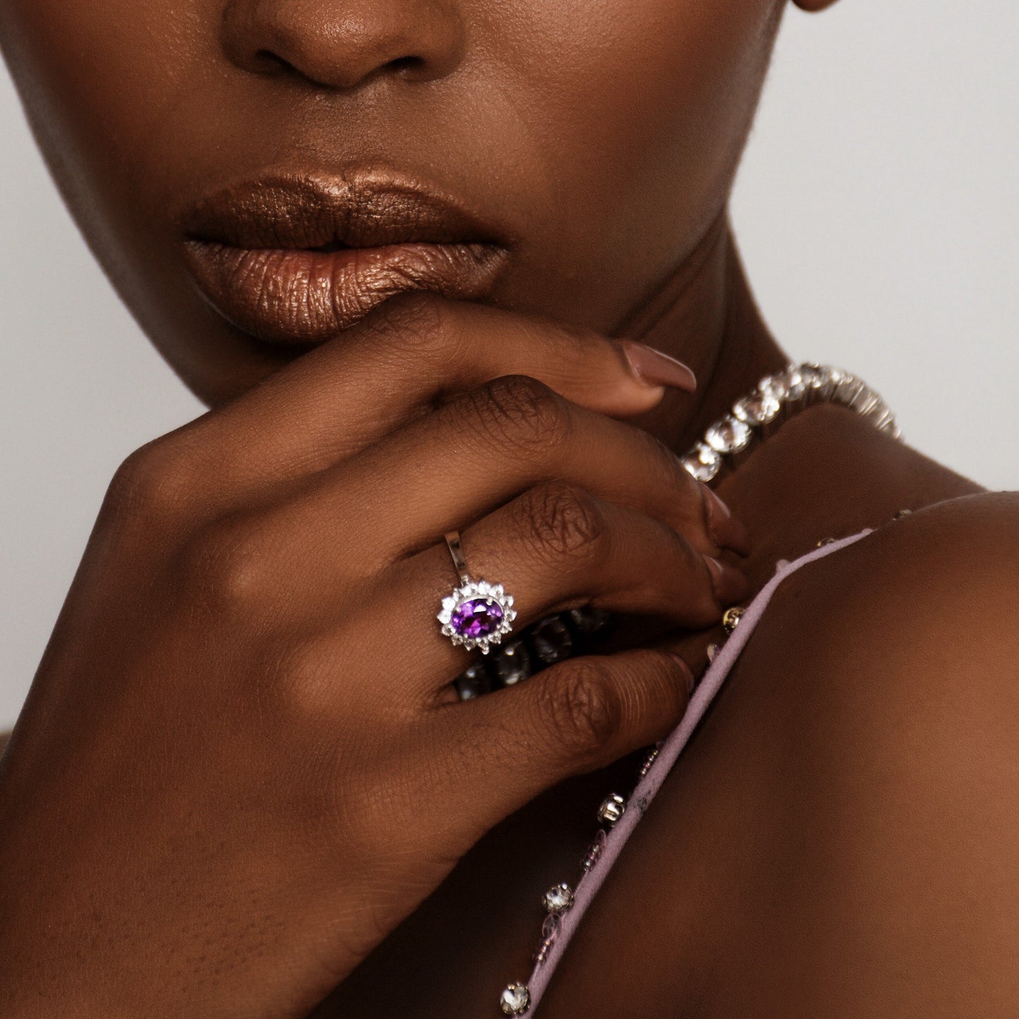 Model elegantly posing with a 2.0ct oval purple amethyst and white zircon ring, highlighting its luxurious and timeless appeal.