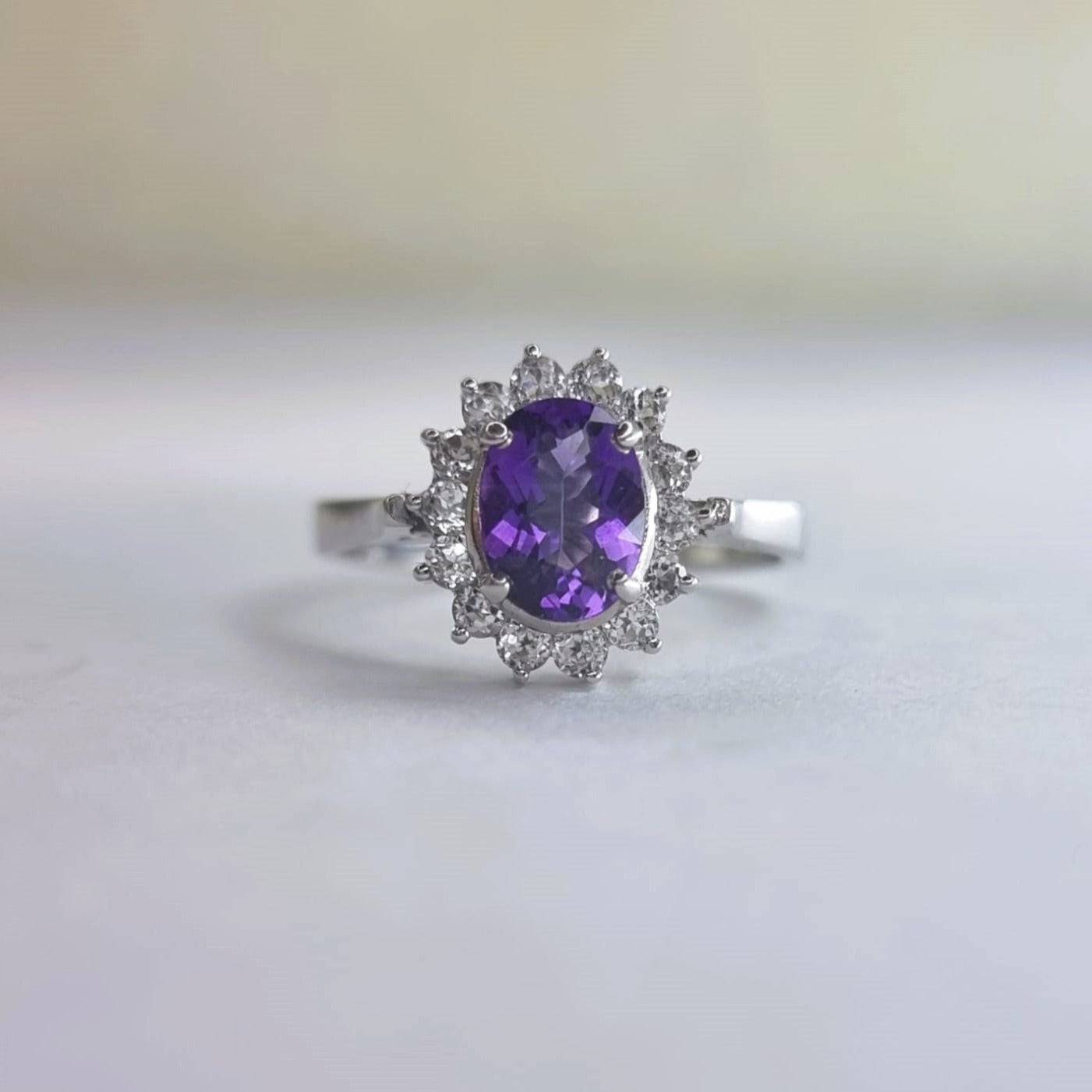 Elegant 2.0ct oval purple amethyst and white zircon statement ring in platinum-coated sterling silver. A luxurious gemstone ring for any occasion.
