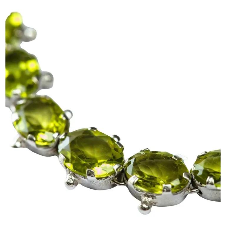 Close-up of Mint Green Peridot Tennis Bracelet showcasing faceted peridot gemstones in sterling silver settings. A radiant and elegant jewelry piece.