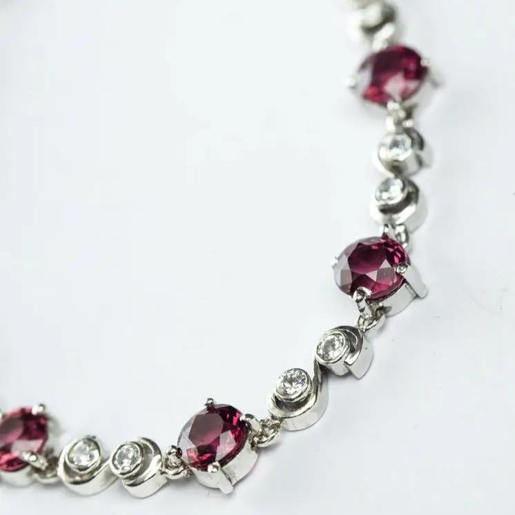 Close-up of 8.25ctw Pink Tourmaline Tennis Bracelet highlighting the intricate details of pink tourmaline and white zircon stones in a silver setting.