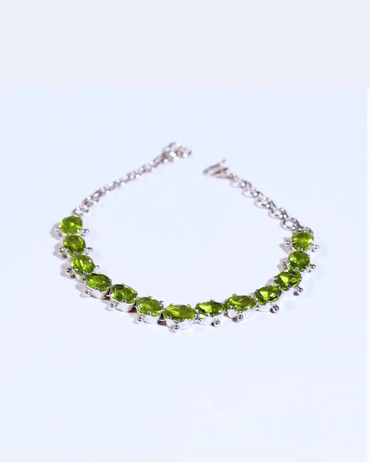 Sterling silver Mint Green Peridot Tennis Bracelet featuring 13ctw of natural gemstones. A stylish and sophisticated accessory for any occasion.
