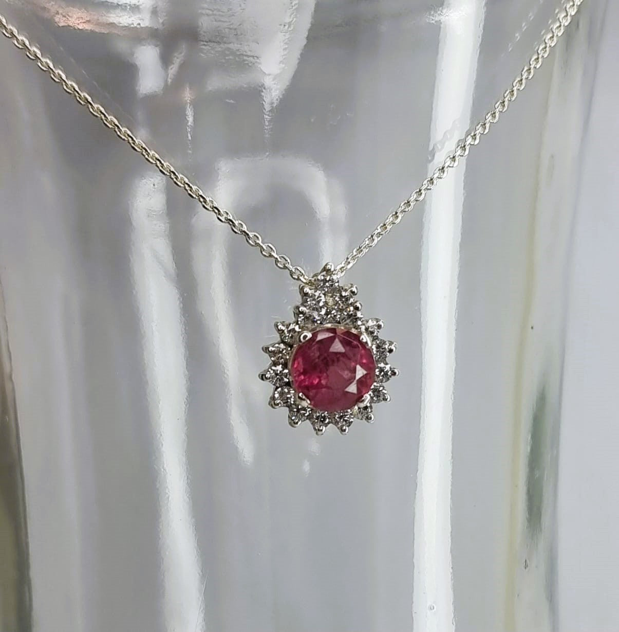 a necklace with a red stone in the center