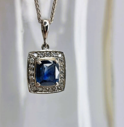 a necklace with a square shaped blue stone surrounded by diamonds