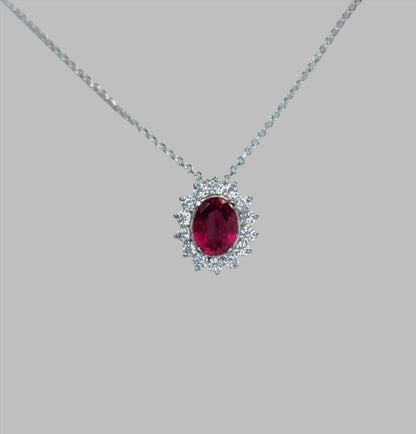 a necklace with a large red stone on a chain