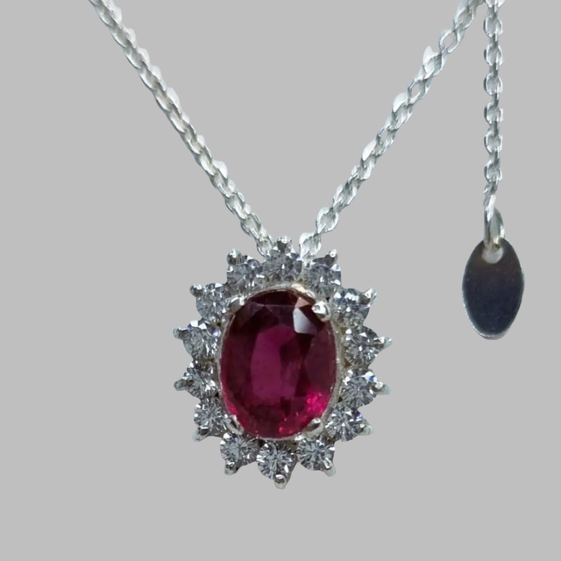 a necklace with a large red stone on it