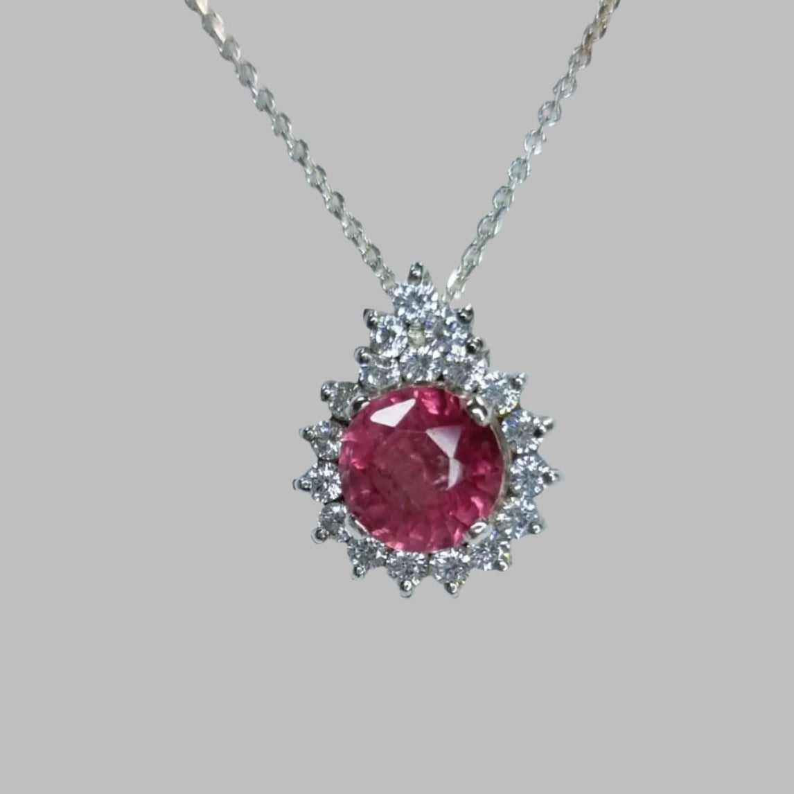 a necklace with a large pink stone in the center