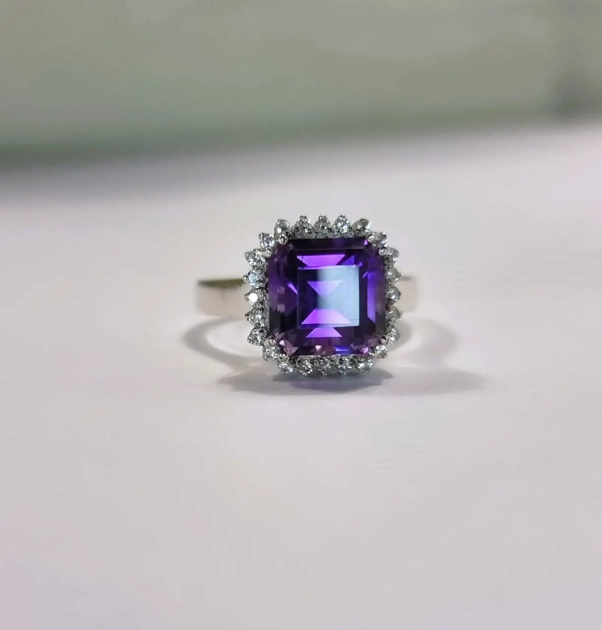 a close up of a ring with a purple stone