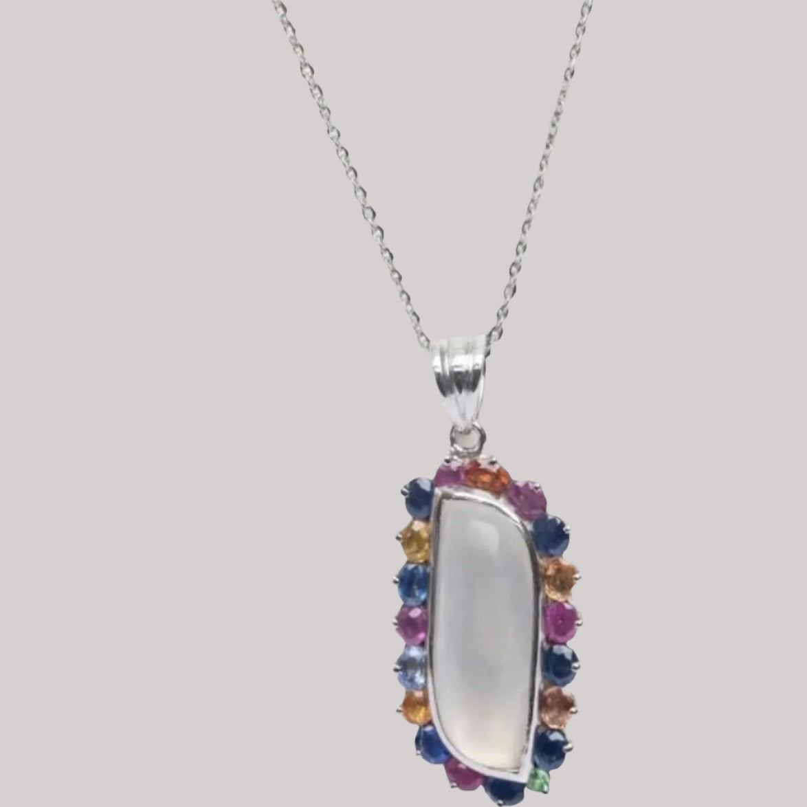 a necklace with a white stone and multicolored stones