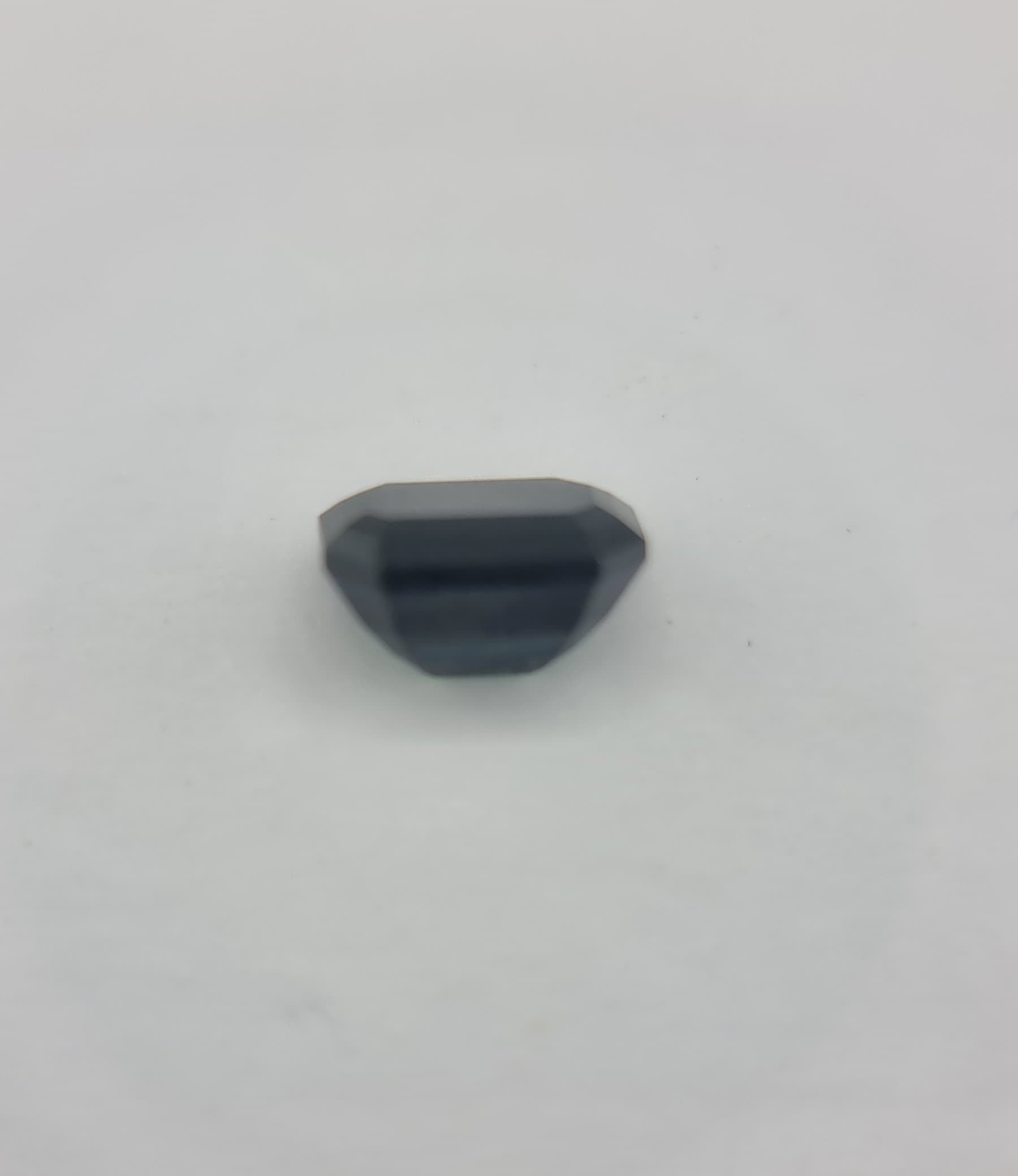Faceted back of 1.84 ctw greenish blue sapphire gemstone with rectangular cut, suitable for high-end jewelry or gemstone enthusiasts.