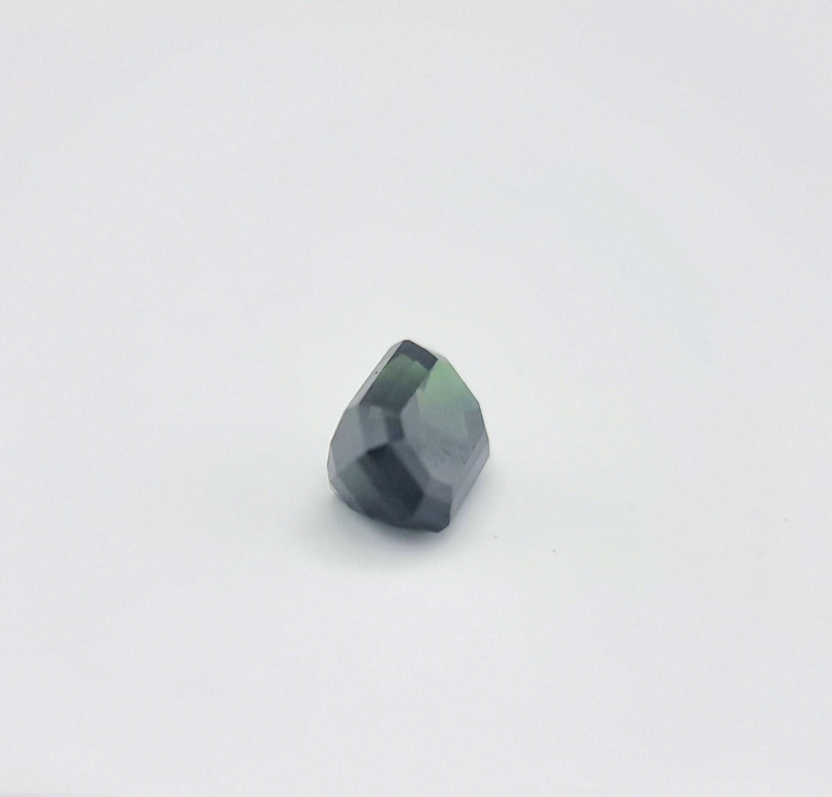 Angled view of rectangular greenish blue sapphire 1.84 ctw, revealing its natural color blend and fine craftsmanship for collectors.
