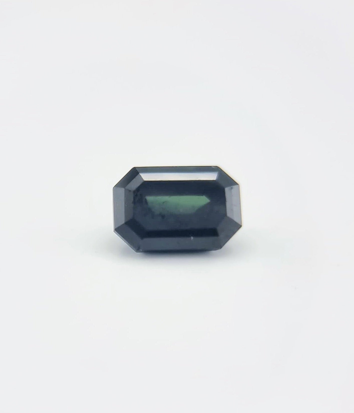 Front-facing rectangular cut greenish blue sapphire 1.84 ctw, ideal for showcasing in artistic jewelry or gemstone displays.