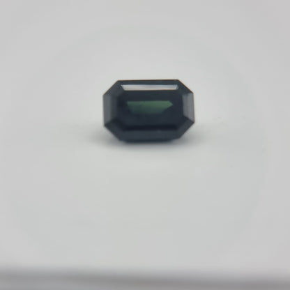 Close-up of 1.84 ctw rectangular greenish blue sapphire with natural hues, perfect for gemstone collectors and creative arts use.