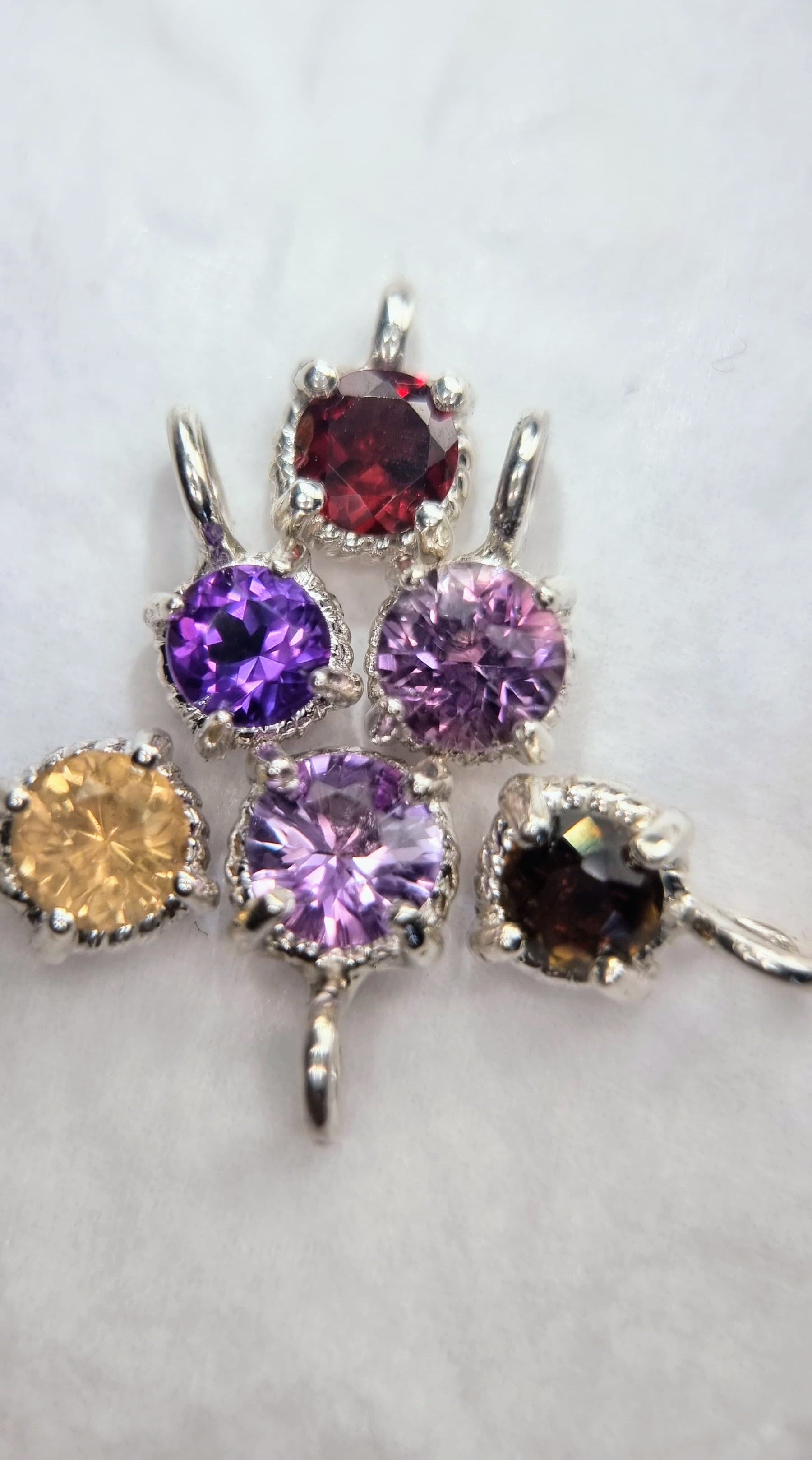 Assorted gemstone pendants including Citrine Sterling Silver Pendant with 6mm round stones in twist settings, ideal for variety in jewelry.