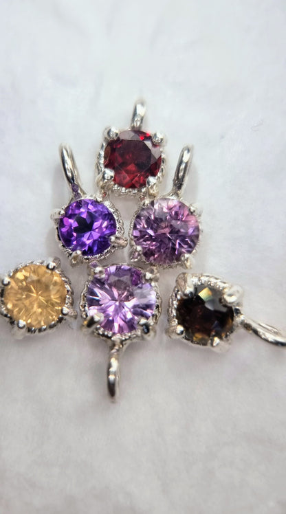 Assorted gemstone pendants including Citrine Sterling Silver Pendant with 6mm round stones in twist settings, ideal for variety in jewelry.