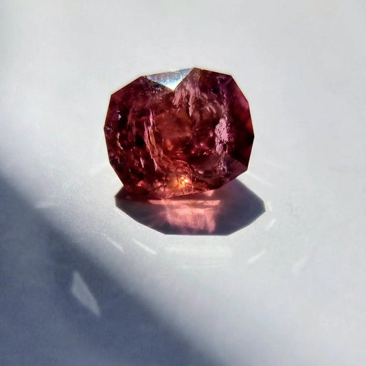 7.42ct Pink Tourmaline Gemstone with cushion cut reflecting deep pink hues under natural light. Ideal for collectors or custom jewelry settings.