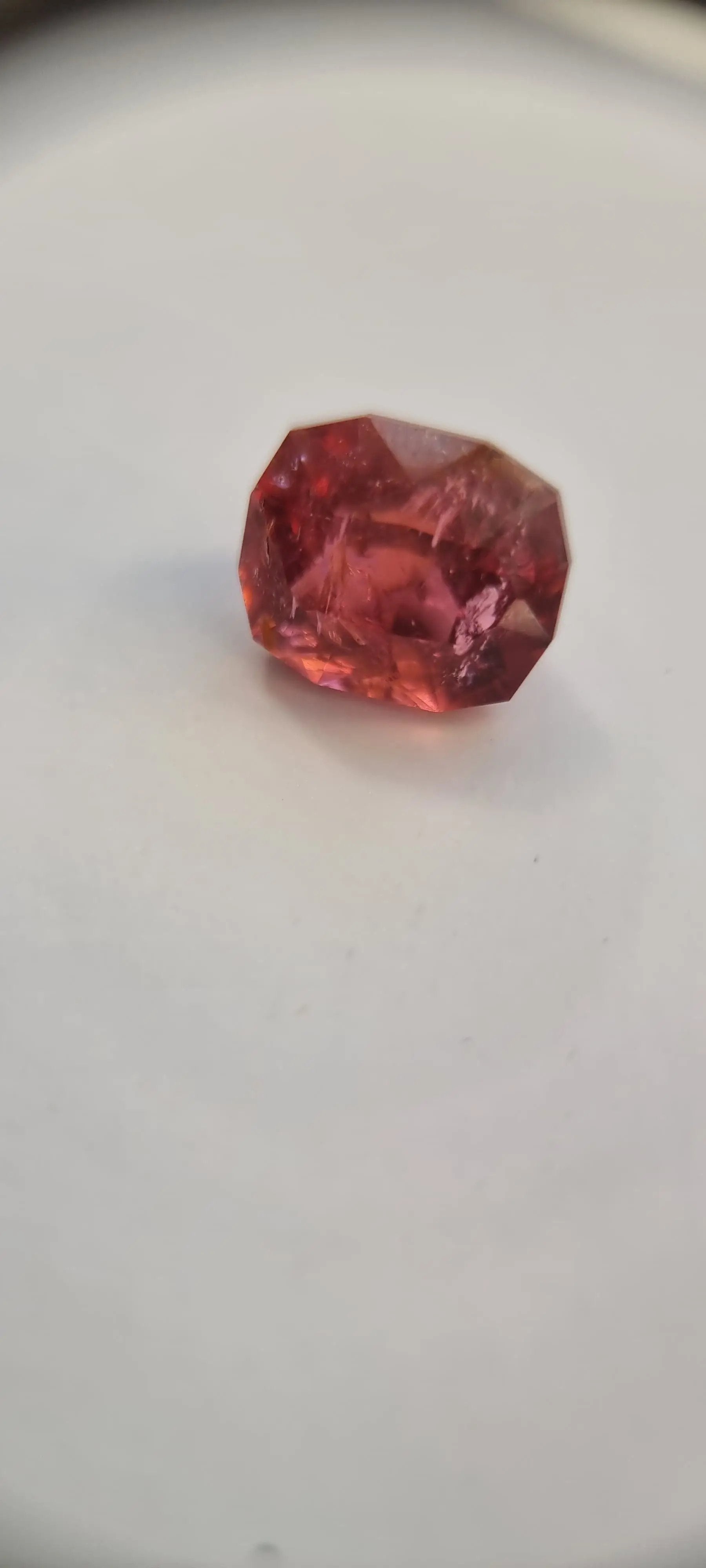 Brilliant 7.42ct Pink Tourmaline Gemstone in cushion cut with vivid pink-orange reflections. Perfect for rings or pendants in gemstone collections.
