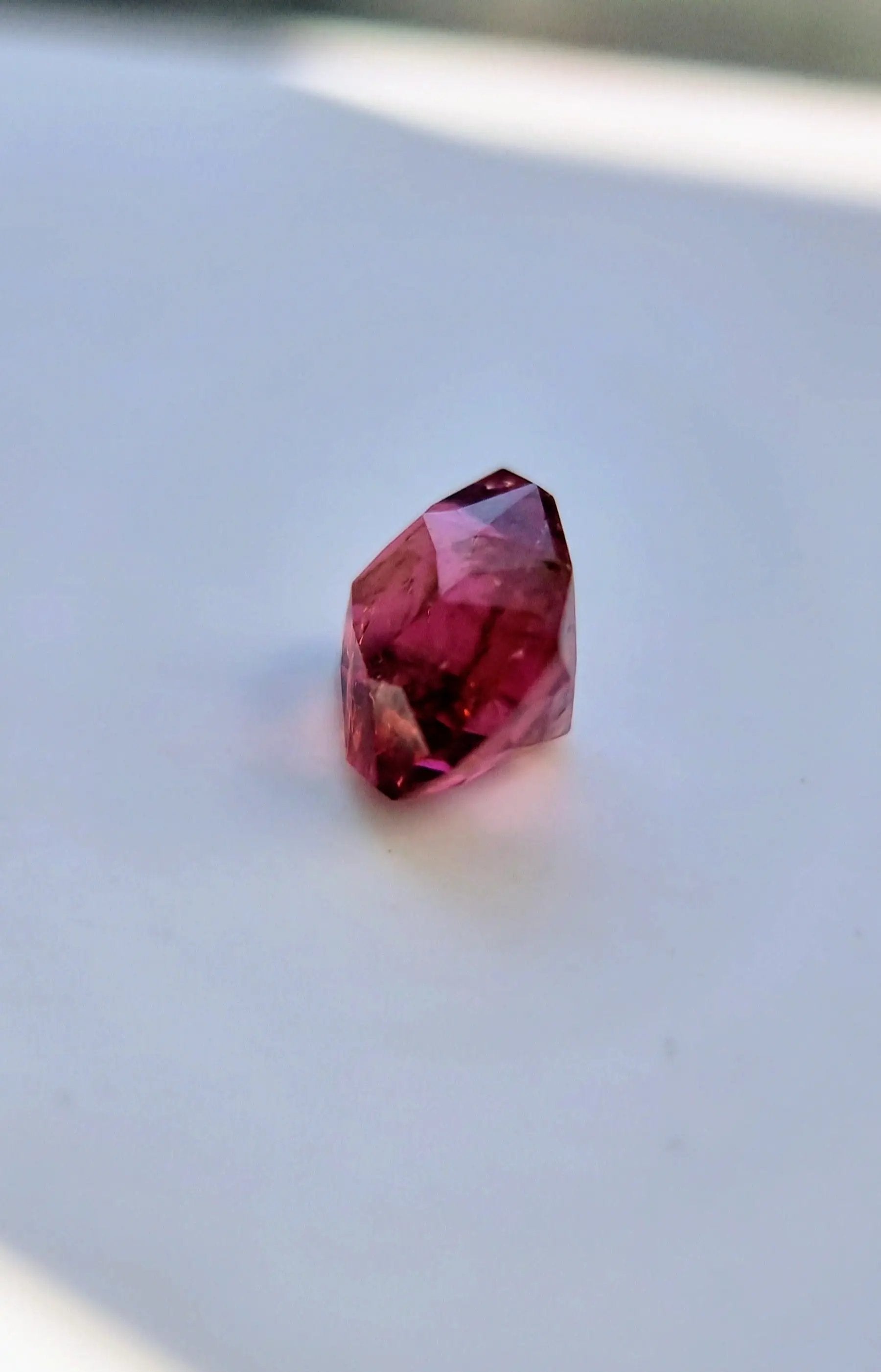 Angled view of 7.42ct Pink Tourmaline Gemstone with cushion cut and deep pink brilliance. Ideal for custom jewelry or gemstone collections.