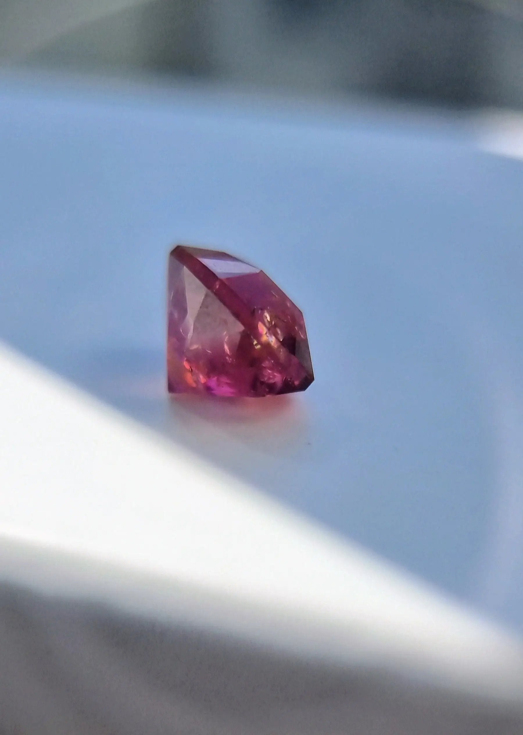 Faceted 7.42ct Pink Tourmaline Gemstone with cushion cut, reflecting pink hues in natural light. A unique gemstone for fine jewelry or gifts.