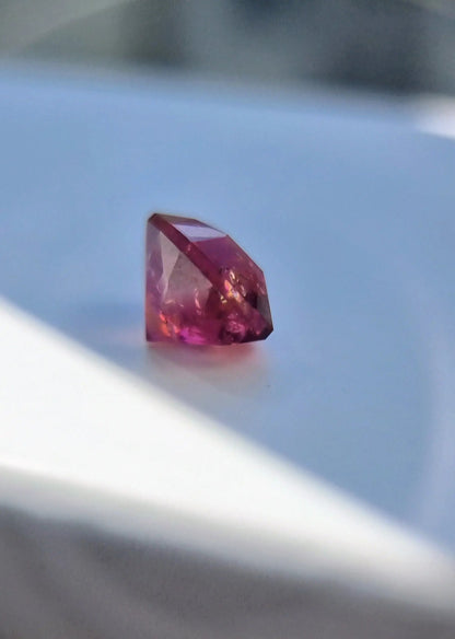 Faceted 7.42ct Pink Tourmaline Gemstone with cushion cut, reflecting pink hues in natural light. A unique gemstone for fine jewelry or gifts.