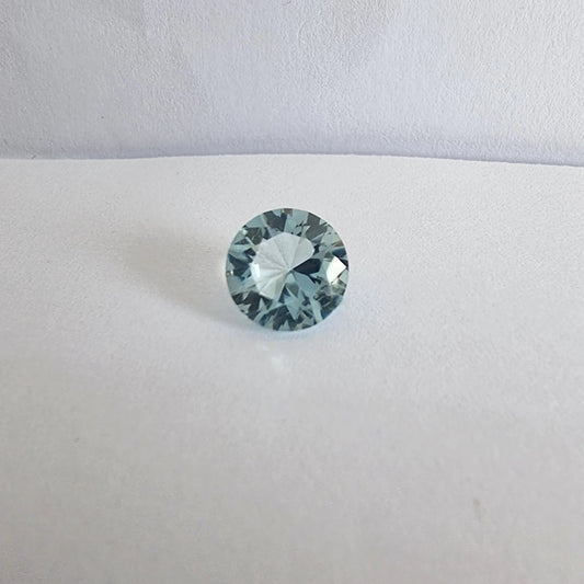 Buy Aquamarine Loose Gemstone - Premium Quality Gems featuring a round-cut aquamarine with brilliant clarity on a white background.