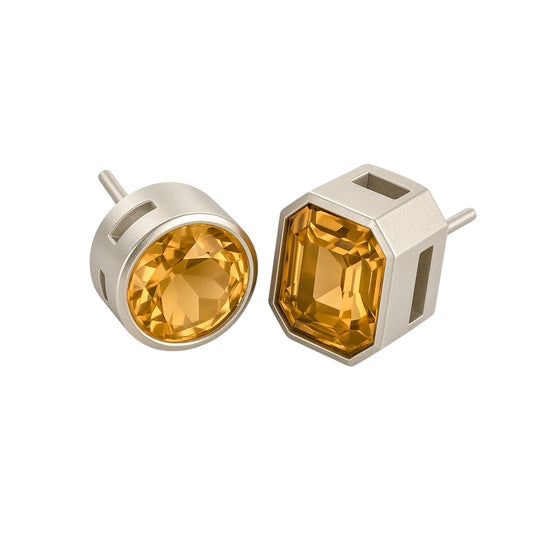 Citrine stud earrings in geometric cage design with mixed cut stones, featuring bezel-set round and emerald citrine in sterling silver settings.
