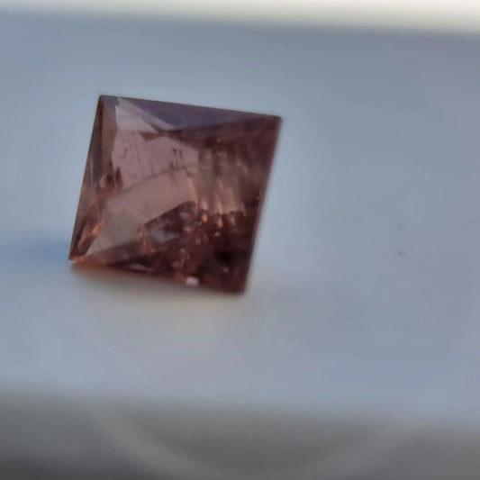 5.13 square cut red tourmaline gemstone with deep rust-red hue, ideal for collectors or custom jewelry in the gemstones category.