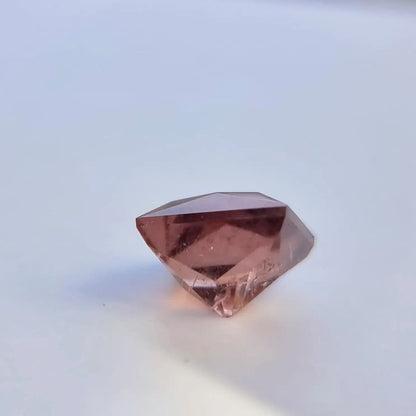 Angled view of 5.13 carat red square cut tourmaline with pinkish-red hue, ideal for gemstone collections or custom rings.
